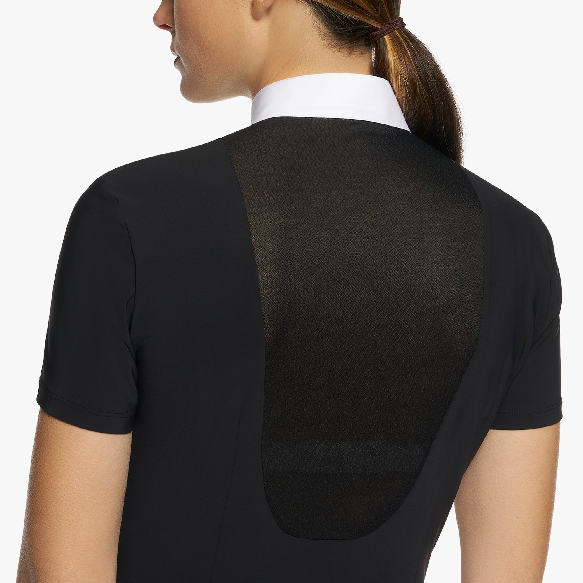This special shirt is dedicated to horsewomen who want to express their femininity even while competing. It has a slim fit to accent the waistline, and the semi-sheer lace panels set into jersey on the front and back add interest to the silhouette. Perfect worn under a show coat, it features an embroidered CT logo, a contrast poplin collar, and a concealed placket that helps create the clean look of the garment.